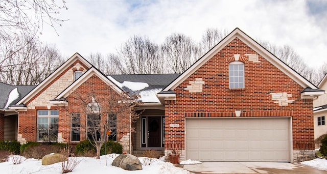 traditional home featuring a garage, stone siding, concrete driveway, and brick siding