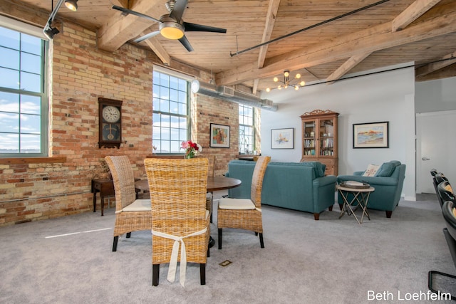 dining space with brick wall, wood ceiling, and beamed ceiling