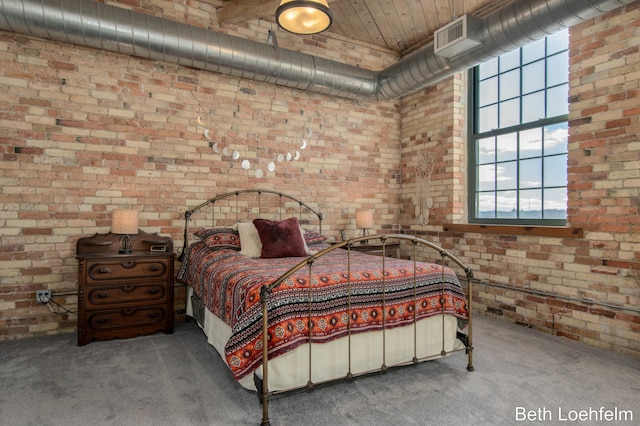 carpeted bedroom featuring wood ceiling, brick wall, and visible vents