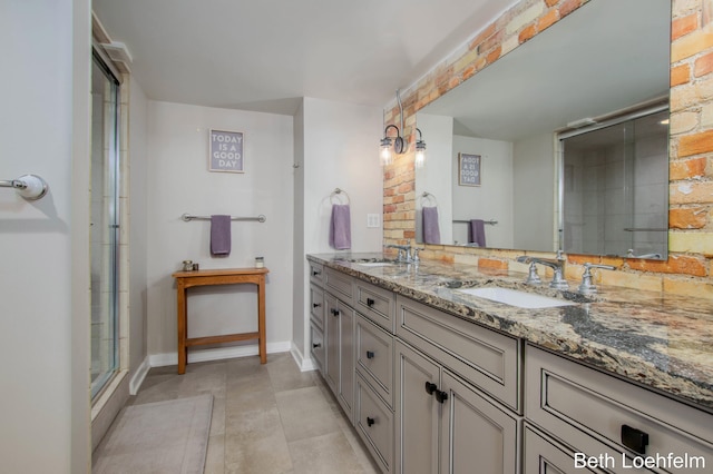 bathroom featuring a shower with door, a sink, baseboards, and double vanity