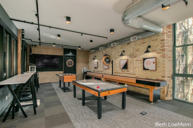 playroom featuring visible vents and brick wall