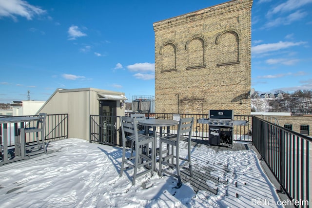 snow covered deck featuring area for grilling