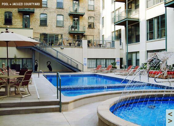 pool with a patio area, a hot tub, and stairs