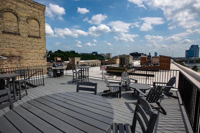 940 Monroe Ave NW # 461, Grand Rapids, MI 49503 - wooden terrace with outdoor dining space and a city view