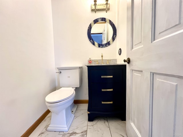 half bath with marble finish floor, vanity, toilet, and baseboards