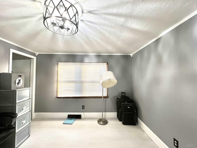 interior space with a textured ceiling, ornamental molding, a notable chandelier, and baseboards