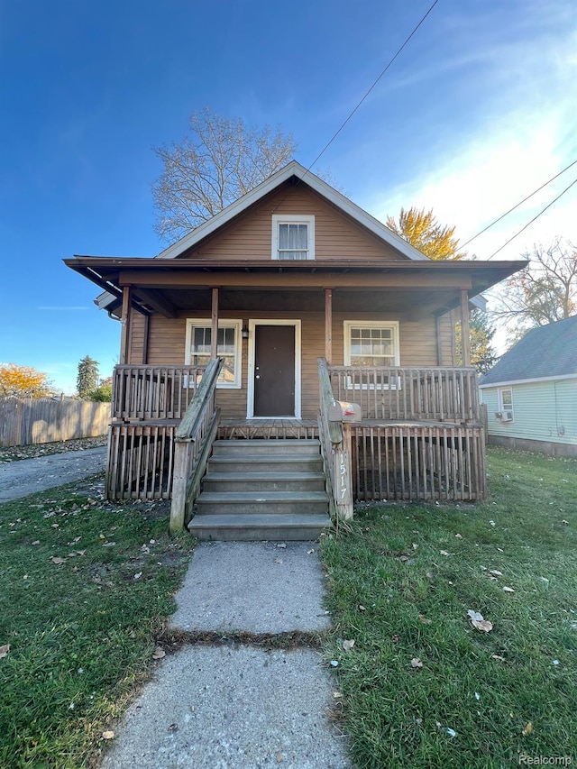 1517 Stanley St, Saginaw, MI 48602 - bungalow-style home featuring a porch and a front lawn