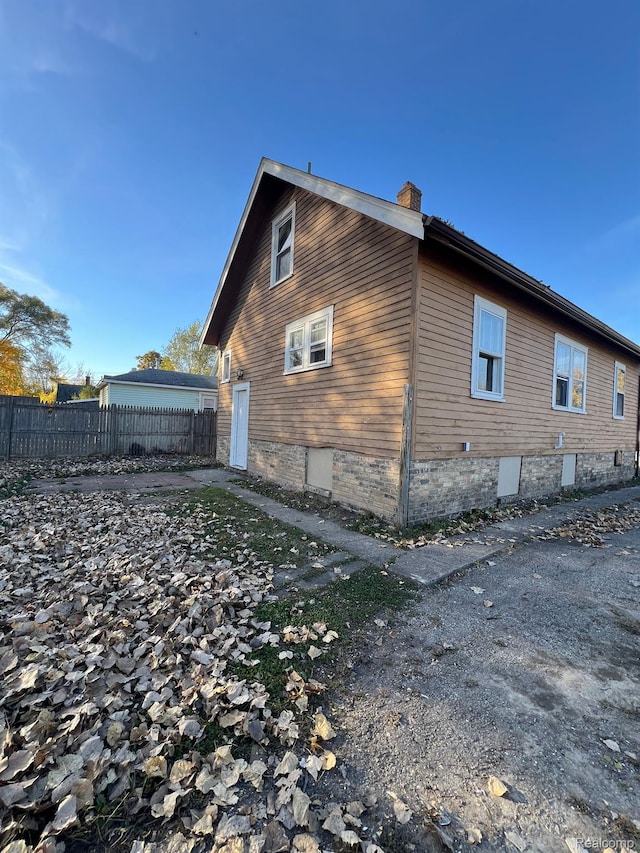 1517 Stanley St, Saginaw, MI 48602 - view of side of property with a chimney