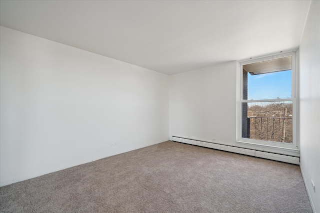 carpeted empty room featuring a baseboard radiator