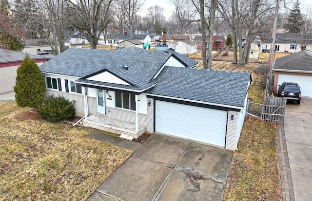 single story home featuring an attached garage, brick siding, a residential view, and a shingled roof