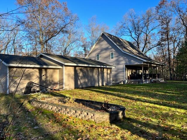 view of side of home with a lawn