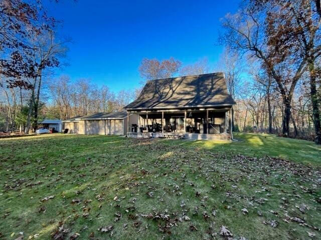 back of property with a lawn