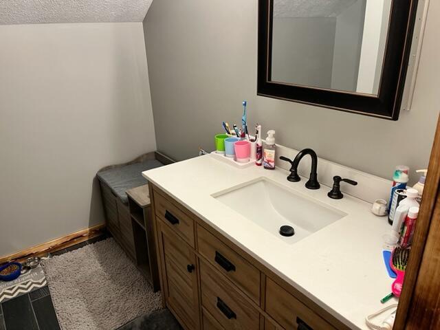 bathroom featuring a textured ceiling and vanity