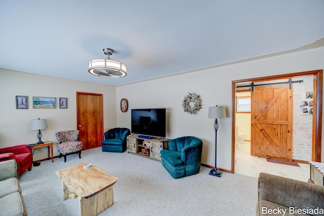 living area with a barn door, carpet, and baseboards