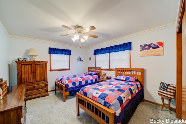 bedroom featuring a ceiling fan, light carpet, and baseboards