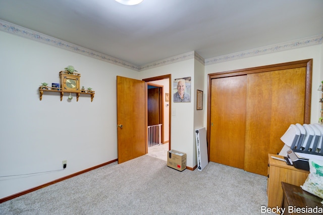 bedroom featuring a closet, carpet flooring, and baseboards