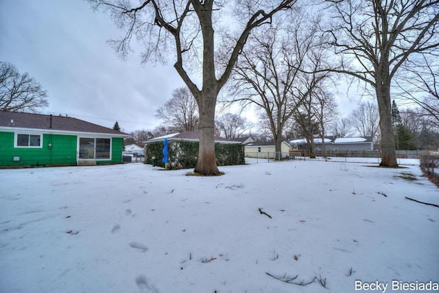 snowy yard with fence