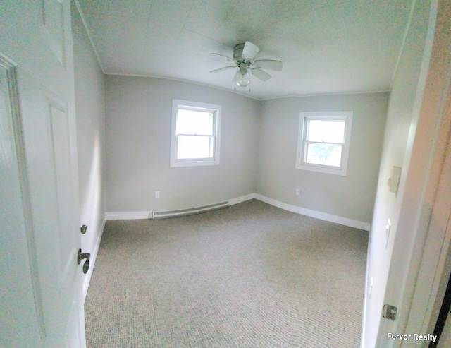 carpeted spare room featuring baseboards, a healthy amount of sunlight, and baseboard heating