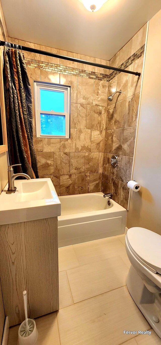 bathroom with toilet, tile patterned floors, shower / bathtub combination with curtain, and vanity