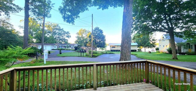 deck with a residential view and a lawn