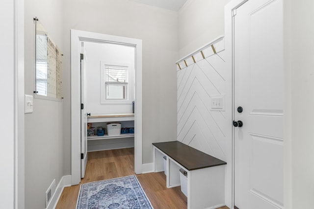 mudroom with light wood-type flooring, visible vents, and baseboards