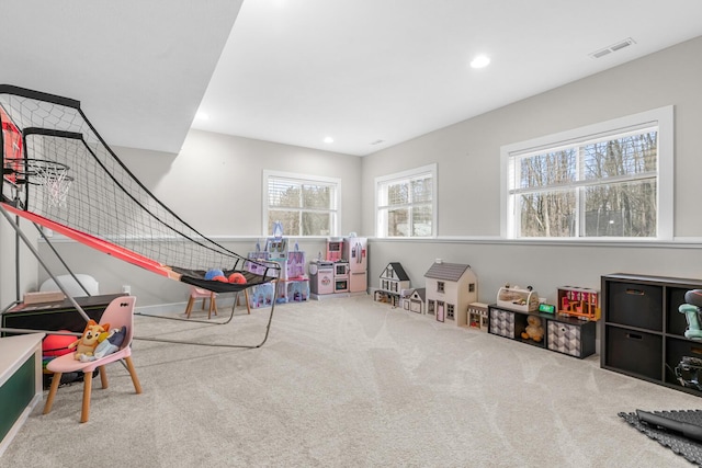 rec room with carpet, visible vents, and recessed lighting