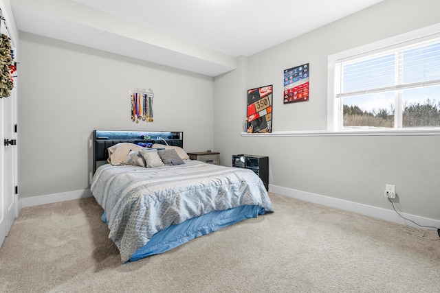 carpeted bedroom featuring baseboards