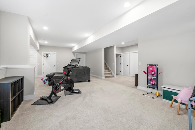 exercise area with light carpet, baseboards, and recessed lighting