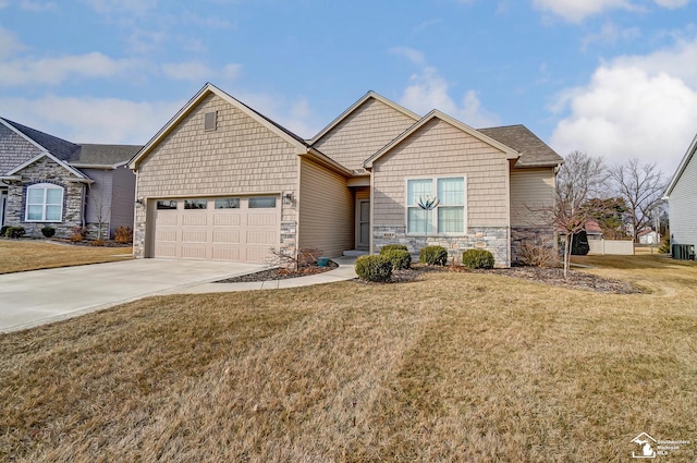 craftsman-style house featuring stone siding, concrete driveway, a front lawn, and a garage