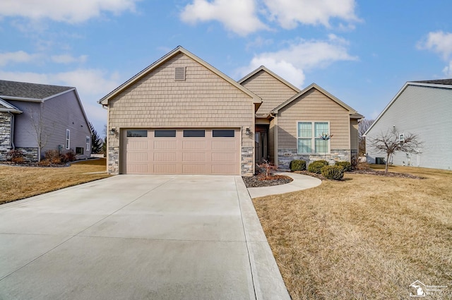 view of front of property with a garage, driveway, a front lawn, and stone siding