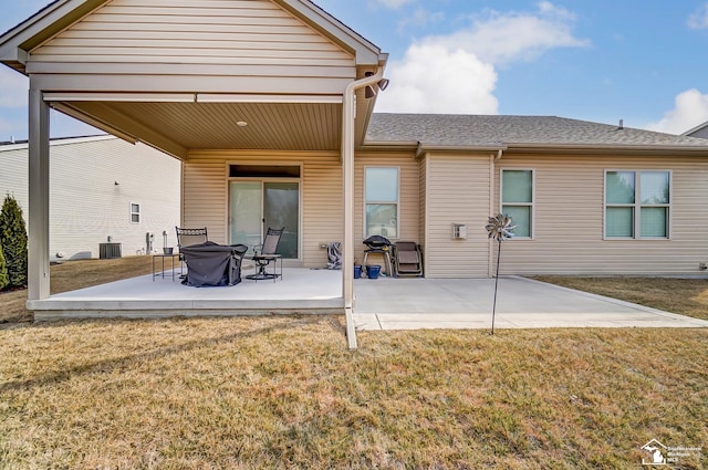 back of property featuring a patio area, central AC unit, a lawn, and roof with shingles