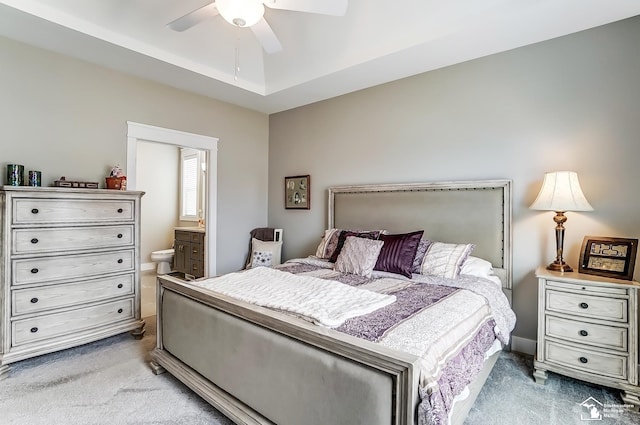 carpeted bedroom with ensuite bathroom and ceiling fan