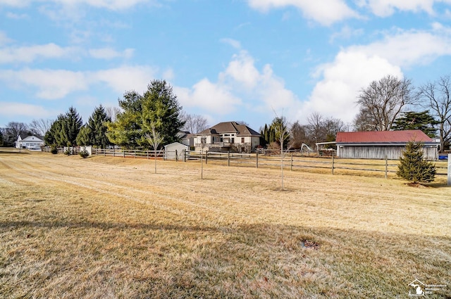 view of yard with a rural view and fence