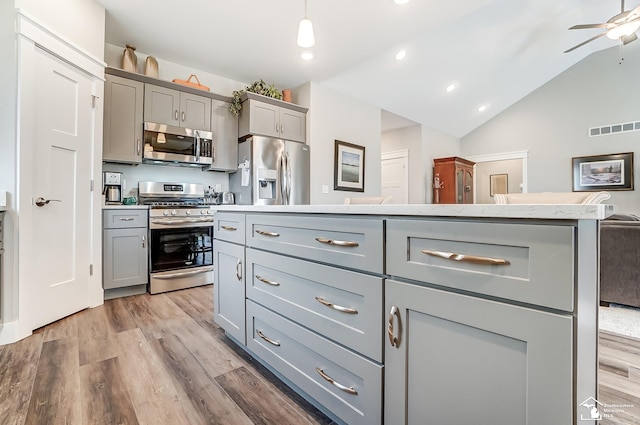 kitchen with visible vents, appliances with stainless steel finishes, wood finished floors, and gray cabinetry