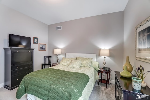 carpeted bedroom with visible vents and baseboards