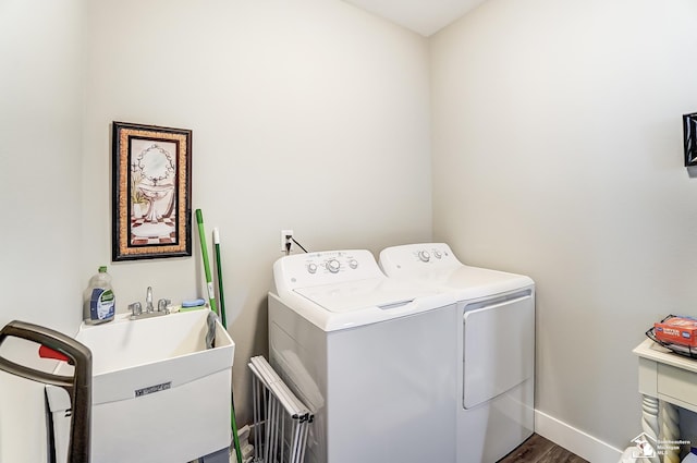 laundry area featuring baseboards, laundry area, dark wood-style flooring, and washer and dryer