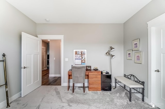 carpeted office space with baseboards