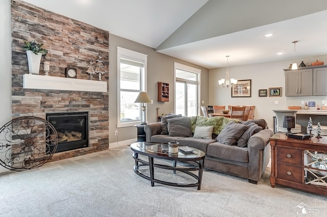 living area featuring lofted ceiling, recessed lighting, light colored carpet, a stone fireplace, and a chandelier