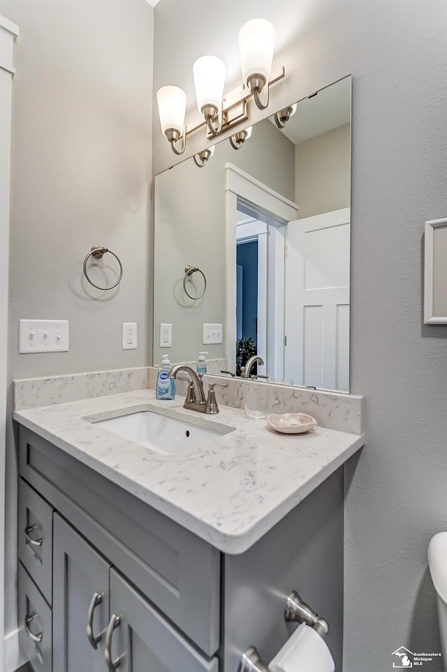 half bath featuring toilet and vanity