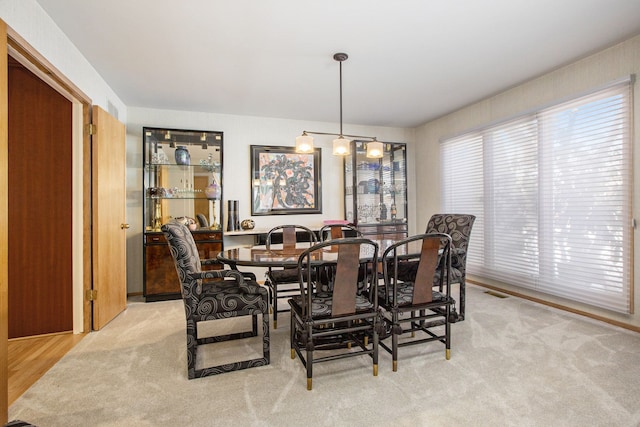 carpeted dining area with visible vents