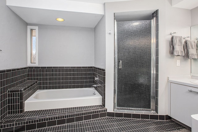 full bath with a shower stall, tile patterned floors, vanity, and a garden tub
