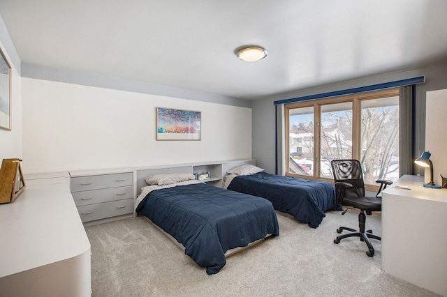 bedroom featuring light carpet