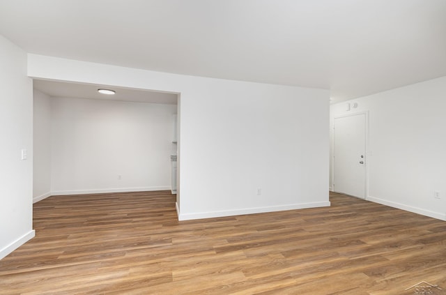 spare room with light wood finished floors and baseboards