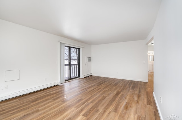 empty room with light wood-style floors, a baseboard radiator, a baseboard heating unit, and baseboards