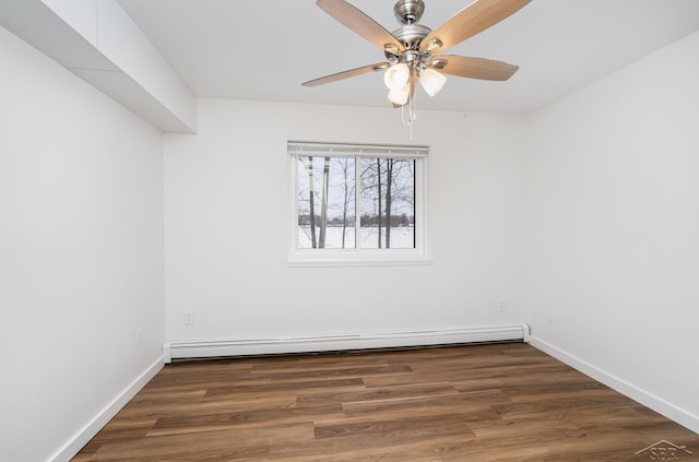 spare room with a baseboard heating unit, ceiling fan, baseboards, and wood finished floors