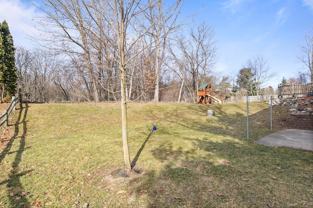 view of yard with fence and a playground