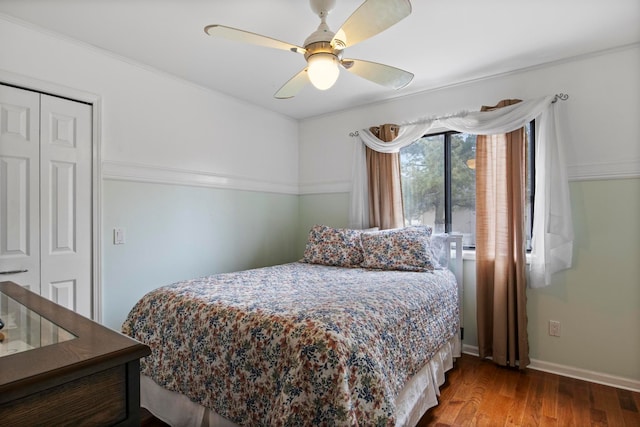 bedroom featuring a ceiling fan, wood finished floors, a closet, and baseboards