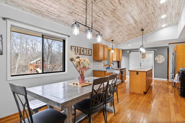 dining space with wooden ceiling, light wood-style flooring, and lofted ceiling