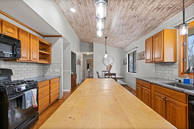 kitchen featuring butcher block counters, wood ceiling, wood finished floors, black appliances, and a sink