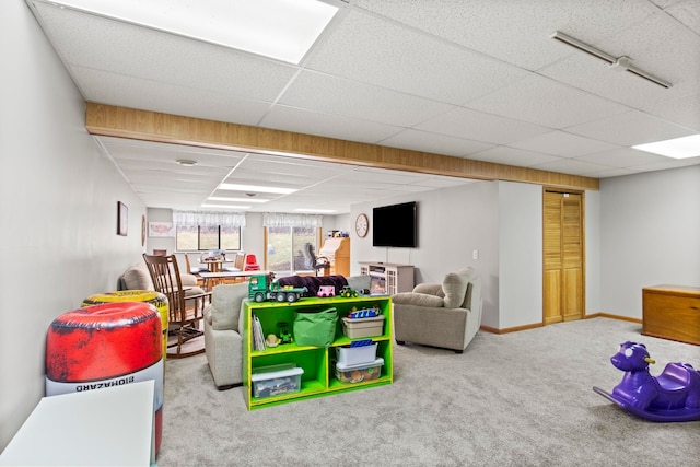 game room featuring carpet flooring, baseboards, and a drop ceiling